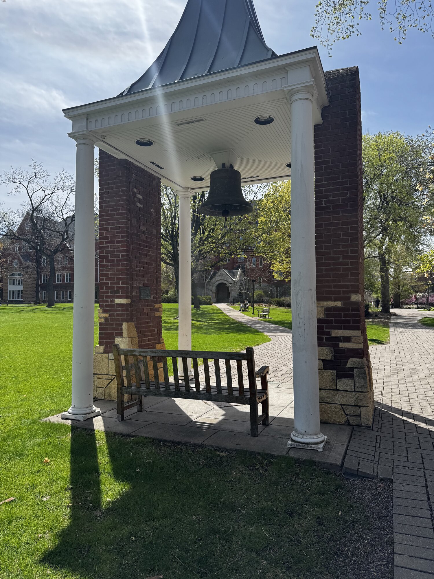 The historic bell tower on Macalester's quad with Old Main in the background